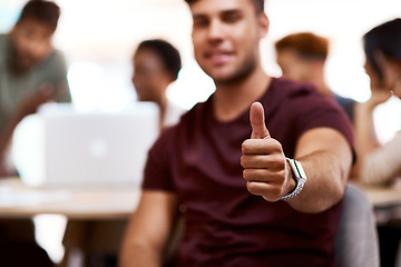 Image showing Stay positive and you will prosper. Closeup shot of a young businessman showing thumbs up in an office.