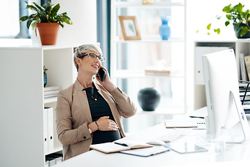 Image showing Ill be out of the office soon. a pregnant businesswoman talking on a cellphone in an office.