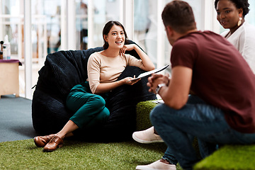 Image showing Providing the right environment helps promote creativity in the workplace. a young businesswoman having a discussion with her colleagues while sitting on a beanbag in an office.