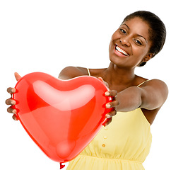 Image showing Cupid, Im counting on you. Studio shot of a young woman holding a red heart against a white background.