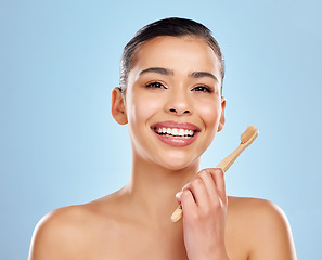 Image showing Make the white choice for your smile. Studio portrait of an attractive young woman brushing her teeth against a blue background.