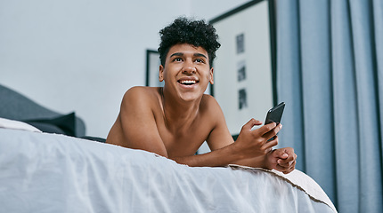 Image showing Texting people you never thought youd text, welcome to lockdown. a young man relaxing on his bed and using a smartphone.