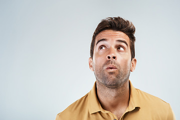 Image showing Im still waiting. Studio shot of a young man with a confused facial expression while standing against a grey background.