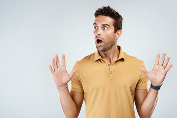 Image showing Wait did that just happen. Studio shot of a young man with a surprised facial expression while standing against a grey background.