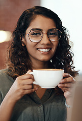 Image showing Once you’ve had their cappuccino you’ll never want anyone else’s. Portrait of a young woman having coffee in a cafe.