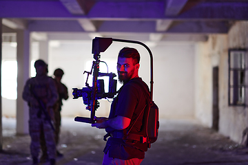 Image showing A professional cameraman captures the intense moments as a group of skilled soldiers embarks on a dangerous mission inside an abandoned building, their actions filled with suspense and bravery