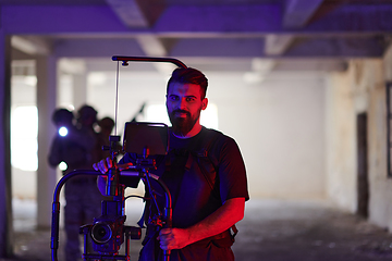 Image showing A professional cameraman captures the intense moments as a group of skilled soldiers embarks on a dangerous mission inside an abandoned building, their actions filled with suspense and bravery