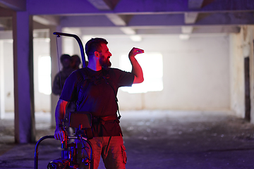 Image showing A professional cameraman captures the intense moments as a group of skilled soldiers embarks on a dangerous mission inside an abandoned building, their actions filled with suspense and bravery