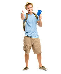 Image showing Flights are back in business. Full length shot of a young tourist standing in the studio and showing a thumbs up while holding his passport.