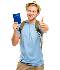 Image showing Ive got all I need for my holiday. a young tourist standing in the studio and showing a thumbs up while holding his passport.