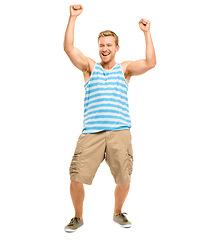 Image showing Yipee. Full length shot of a handsome young man standing alone in the studio with his arms raised in celebration.