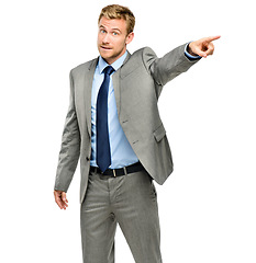 Image showing Youre fired. a handsome young businessman standing alone in the studio and pointing in anger.