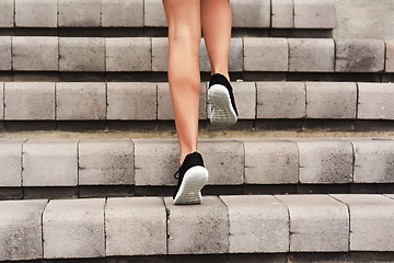 Image showing Levelling up. Rearview shot of an unrecognizable young female athlete working out on a flight of stairs at the track.