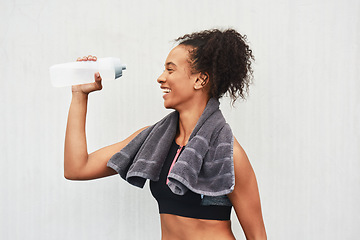Image showing Water breaks are important. an attractive young female athlete drinking water against a grey background.
