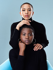 Image showing There is no difference between us really. Portrait of two beautiful young women holding each other while standing against a grey background.