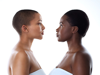 Image showing I see a whole different world when I look into your eyes. Studio shot of two beautiful young women looking into each others eyes while standing against a white background.