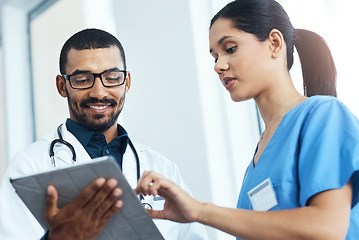 Image showing Successful hospitals run on teamwork. two young doctors using a digital tablet in a modern hospital.