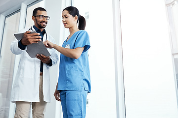 Image showing Going over the details of their diagnosis. two young doctors using a digital tablet in a modern hospital.