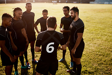 Image showing We never run out of things to talk about. a diverse group of sportsmen standing together before playing rugby during the day.