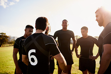 Image showing Getting in some last minute motivation. a diverse group of sportsmen standing together before playing rugby during the day.