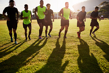 Image showing Building up the momentum. Full length shot of a diverse group of sportsmen warming up before playing rugby during the day.