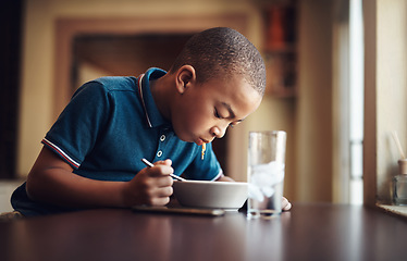 Image showing Hell never say no to a bowl of spaghetti. a young boy eating a bowl of spaghetti at home.