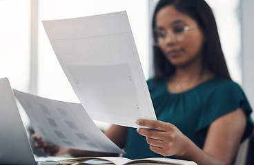 Image showing She always has a big plan in the making. Closeup shot of a young businesswoman going through paperwork in an office.