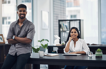 Image showing We always bring a fresh rush of enthusiasm to work. Portrait of a young businesswoman sitting in an office with her colleague in the foreground.