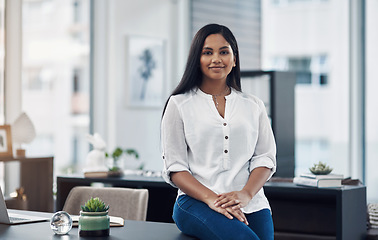 Image showing With confidence, you have won before you have even started. Portrait of a confident young businesswoman in an office.