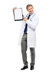 Image showing I just need you to sign this form. Full length shot of a handsome young doctor standing alone in the studio and pointing at a clipboard.