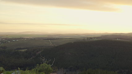 Image showing City, landscape and sky at sunset with mountain in Cape Town, view or panoramic of urban background with clouds, land and nature. Sunrise, skyline and relax or meditation in outdoor environment