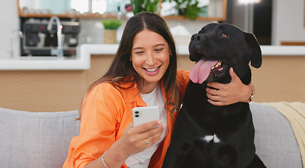 Image showing Happy woman, dog and phone in home living room on sofa for care, hug and friends relax together. Couch, smartphone and person with pet animal bonding on social media, internet app and typing online