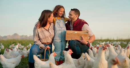 Image showing Parents, girl and hug with chicken, farm and happy with box for food, sustainability and talk in sunshine. Father, mother and daughter with poultry, countryside and environment with smile for birds