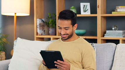 Image showing Relax, smile and asian man with a tablet a sofa for social media, chat or streaming at home. Digital, app and Japanese male in a living room happy for gif, meme or web, post and online communication