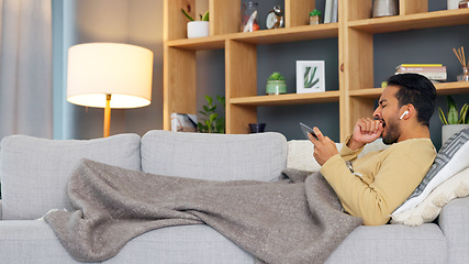 Image showing Man, tired and yawn, smartphone and watch video or film with online streaming, relax on couch and playing games. Mobile app, subscription and fatigue, live streaming at home or tv show and sleepy