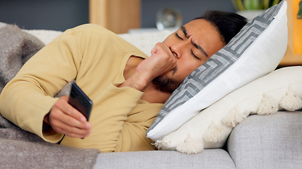 Image showing Man, phone and cough on sofa in home living room, texting or communication with email notification. Guy, smartphone and sick with research for health, medicine or watch video on social media in house