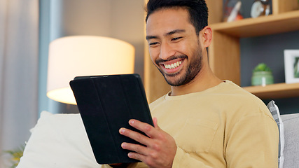 Image showing Laugh, relax and asian man with a tablet a sofa for social media, chat or streaming at home. Digital, app and Japanese male in a living room smile for gif, meme or web, post and online communication