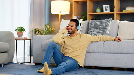 Image showing Man, relax on living room floor and headphone, listening to music with audio streaming, happiness and tech at home. Chill at the weekend, wellness and podcast with sound, connectivity and radio