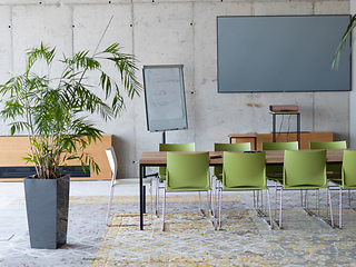 Image showing Interior of a business facility showcasing a well equipped office with a laptop and smartphones, reflecting a modern and efficient work environment.