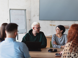 Image showing A diverse group of business professionals gathered at a modern office for a productive and inclusive meeting