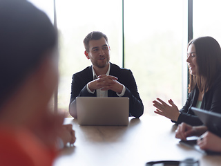 Image showing A diverse group of business professionals gathered at a modern office for a productive and inclusive meeting