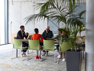 Image showing A diverse group of business professionals gathered at a modern office for a productive and inclusive meeting