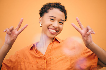 Image showing Peace, hands and happy woman in studio with thank you, gesture and self love against orange background space. freedom, face and female model with v emoji sign for good mood, confidence or positivity