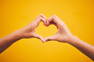 Image showing Heart, hands and person in studio with thank you, message or gesture on orange background space. Emoji, frame and human fingers with self love, gratitude and kindness, empathy and hope of healing