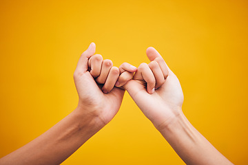 Image showing People, hands and pinky promise in studio with trust, help or hope for reconciliation on yellow background. Finger, emoji and deal by friends with secret, gesture and support expression or solidarity