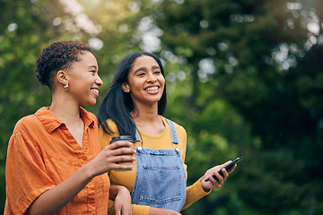 Image showing Phone, happy and women in park with coffee together for holiday, bonding and quality time outdoors. Friendship, nature and female people walking in nature for relaxing, conversation and talking