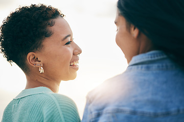 Image showing Sunset, lesbian and couple with love on holiday and smile together on outdoor vacation in the morning with romance. Lgbtq, pride and women bonding on a summer date for adventure, relax and happiness