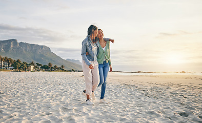 Image showing Love, beach and lesbian couple hug while walking together on sand, sunset holiday adventure or date. Lgbt women, bonding and relax on ocean vacation with romance, pride and happy travel in nature.