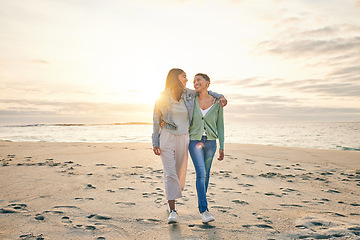 Image showing Love, beach and sunset, lesbian couple walking together on sand mockup, sunset holiday and hug on date. Lgbt women, bonding and relax on ocean vacation with romance, pride and happy nature travel.