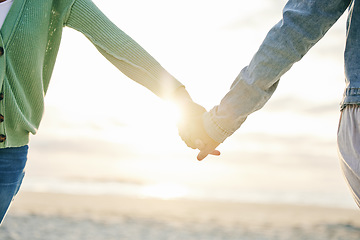 Image showing Woman couple, holding hands and beach for love, support or lesbian pride in trust on outdoor vacation. Closeup of gay women touching in relationship together for LGBTQ romance by the ocean coast